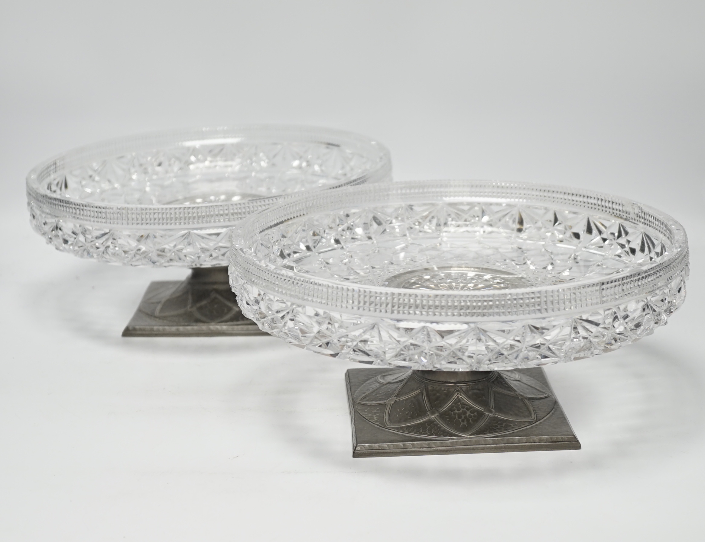 A pair of Tudric pewter based tazza with cut glass bowls, bowls 28cm diameter